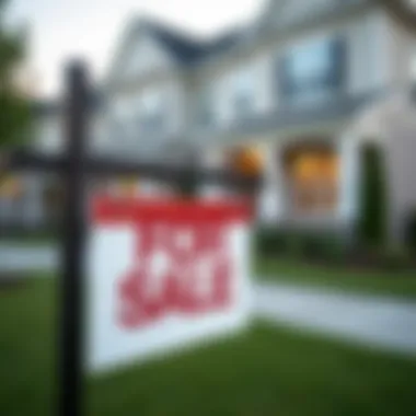 A close-up of a 'For Sale' sign in front of a townhome